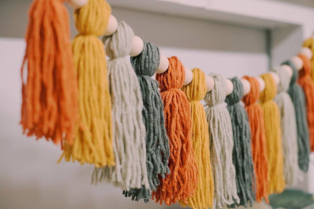 how to make a fall-colored yarn tassel garland