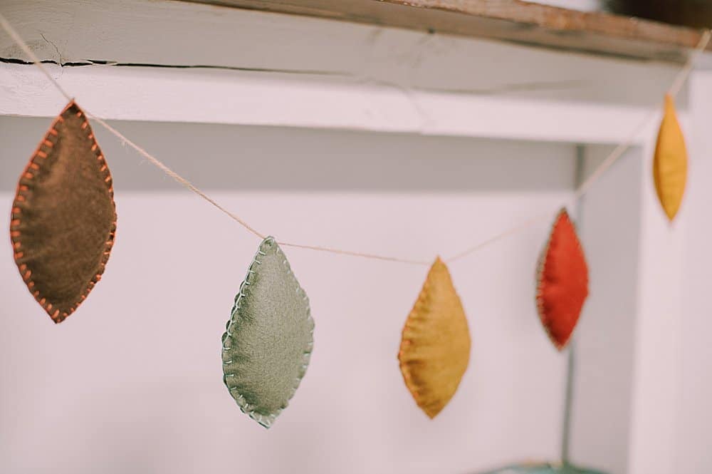Learn how to make a felt leaf garland using felt leaves, stuffed with fiber fill and embroidered with a blanket stitch, and strung with twine!