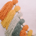 How to make a fall yarn tassel garland using yarn that is autumn hued in color.