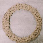 How to make a burlap ribbon wreath using a wire wreath form and burlap ribbon.