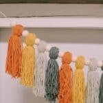 How to make a Fall Tassel Garland using yarn and wooden beads and twine as the hanging string.
