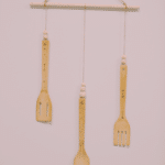 How to make a DIY woodburned wall hanging using wooden kitchen utensils