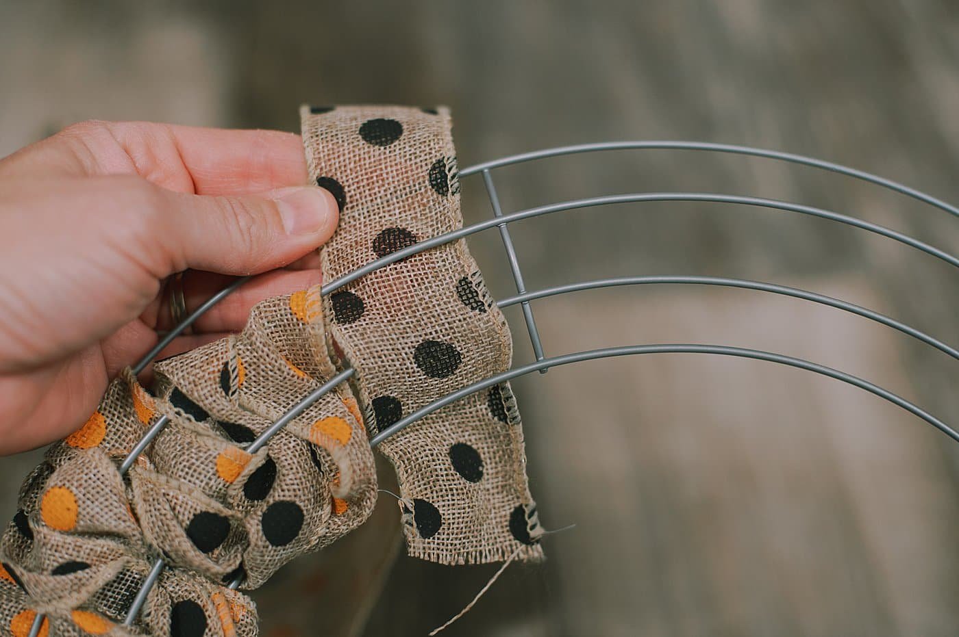 Wind burlap ribbon in and out of the wire wreath form to make a wreath.