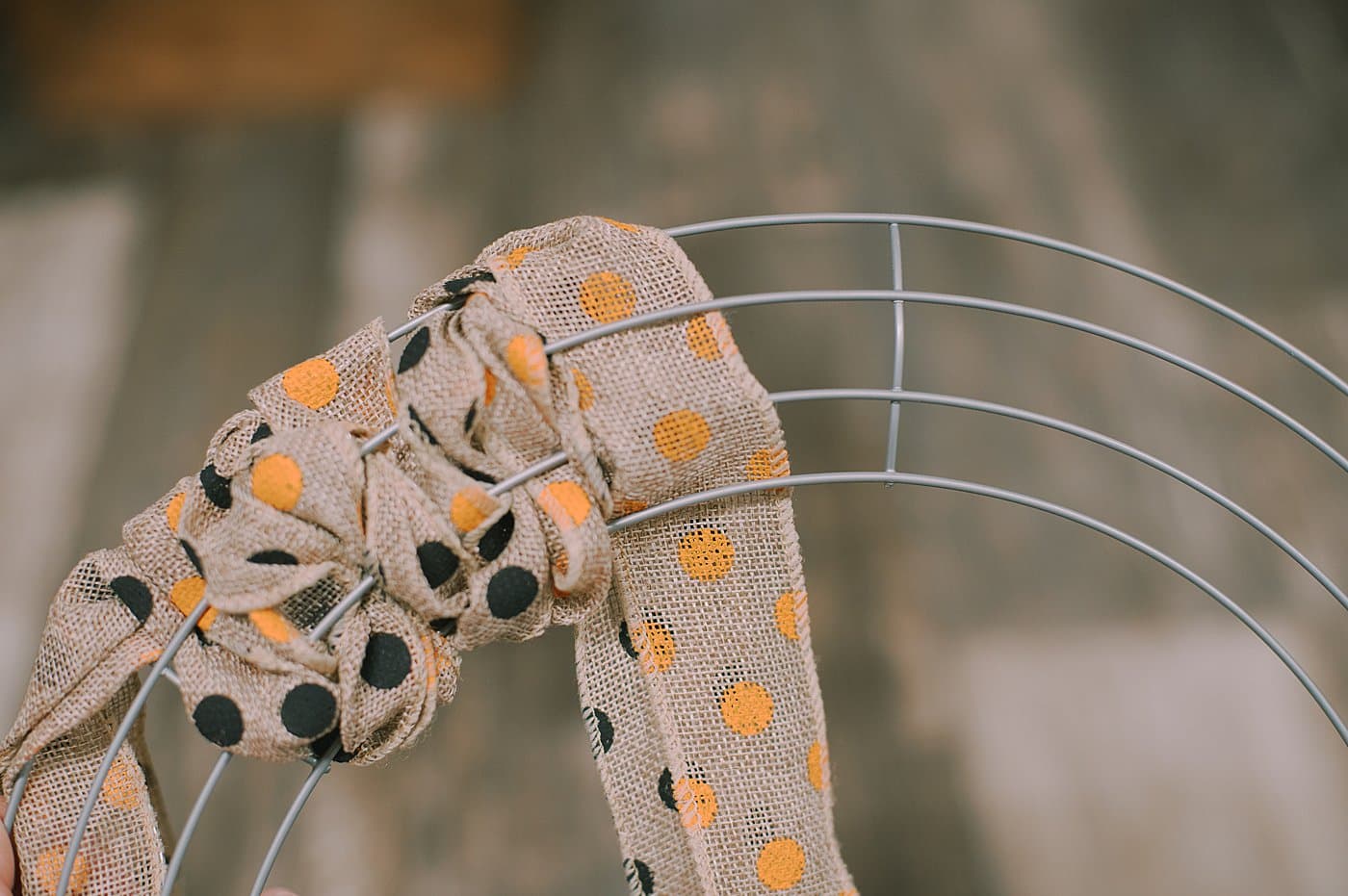 Wind burlap ribbon in and out of the wire wreath form to make a wreath.