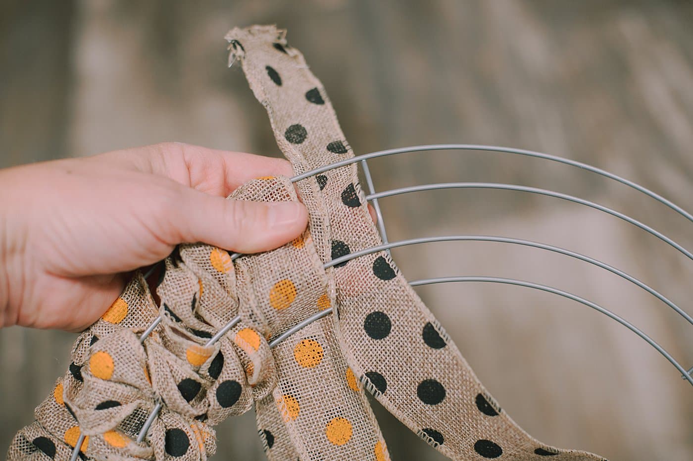 Wind burlap ribbon in and out of the wire wreath form to make a wreath.