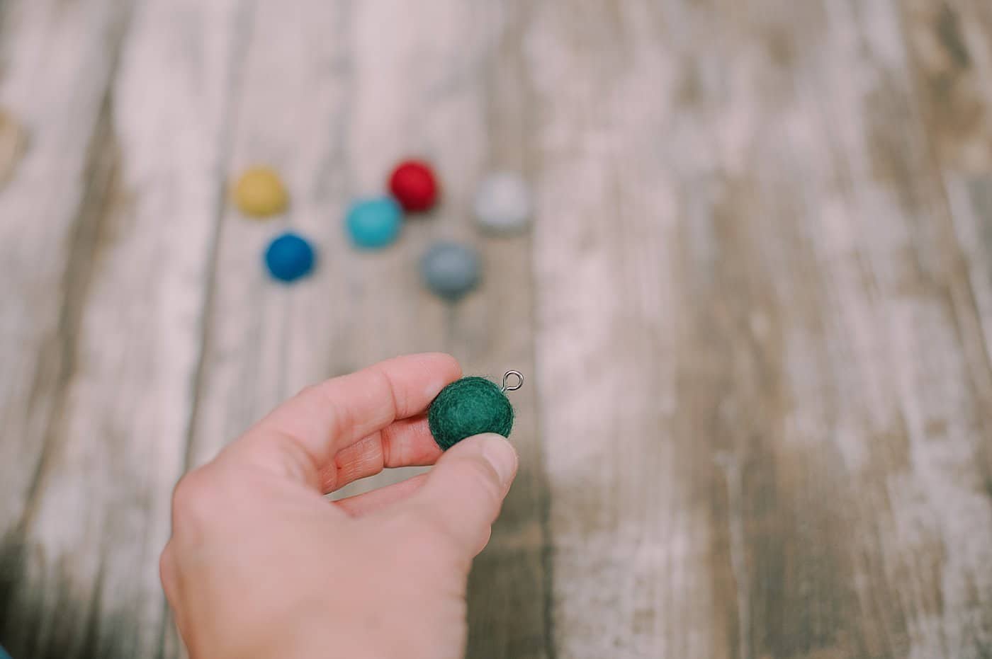 Add screw loop to the top of the felt ball.