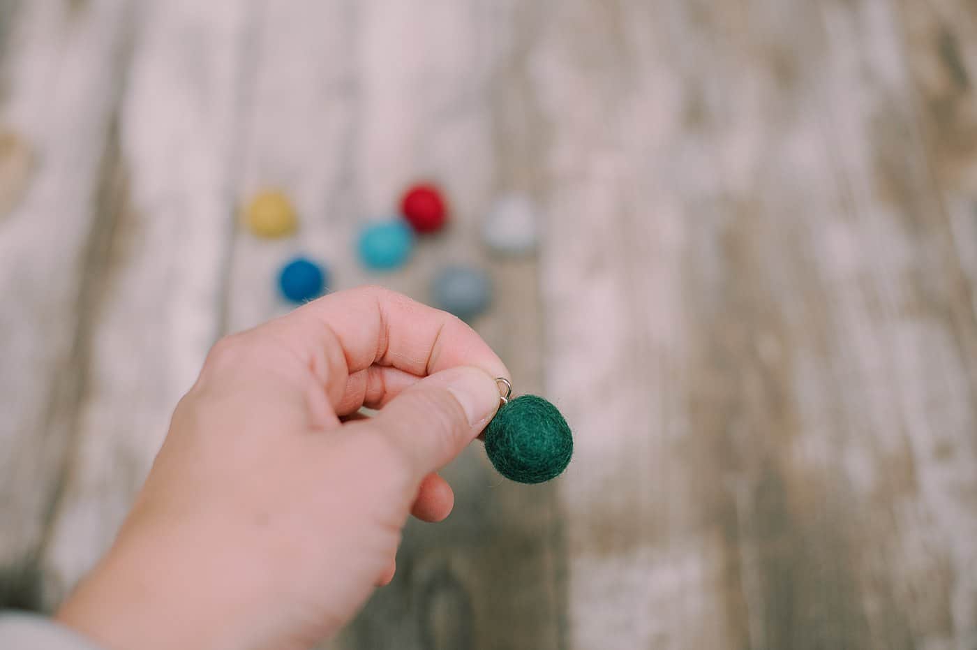 Add screw loop to the top of the felt ball.