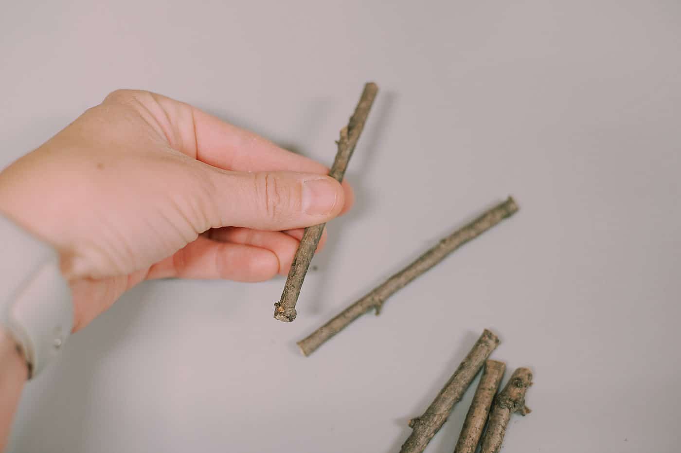 Hot glue sticks into shapes to make christmas ornaments.