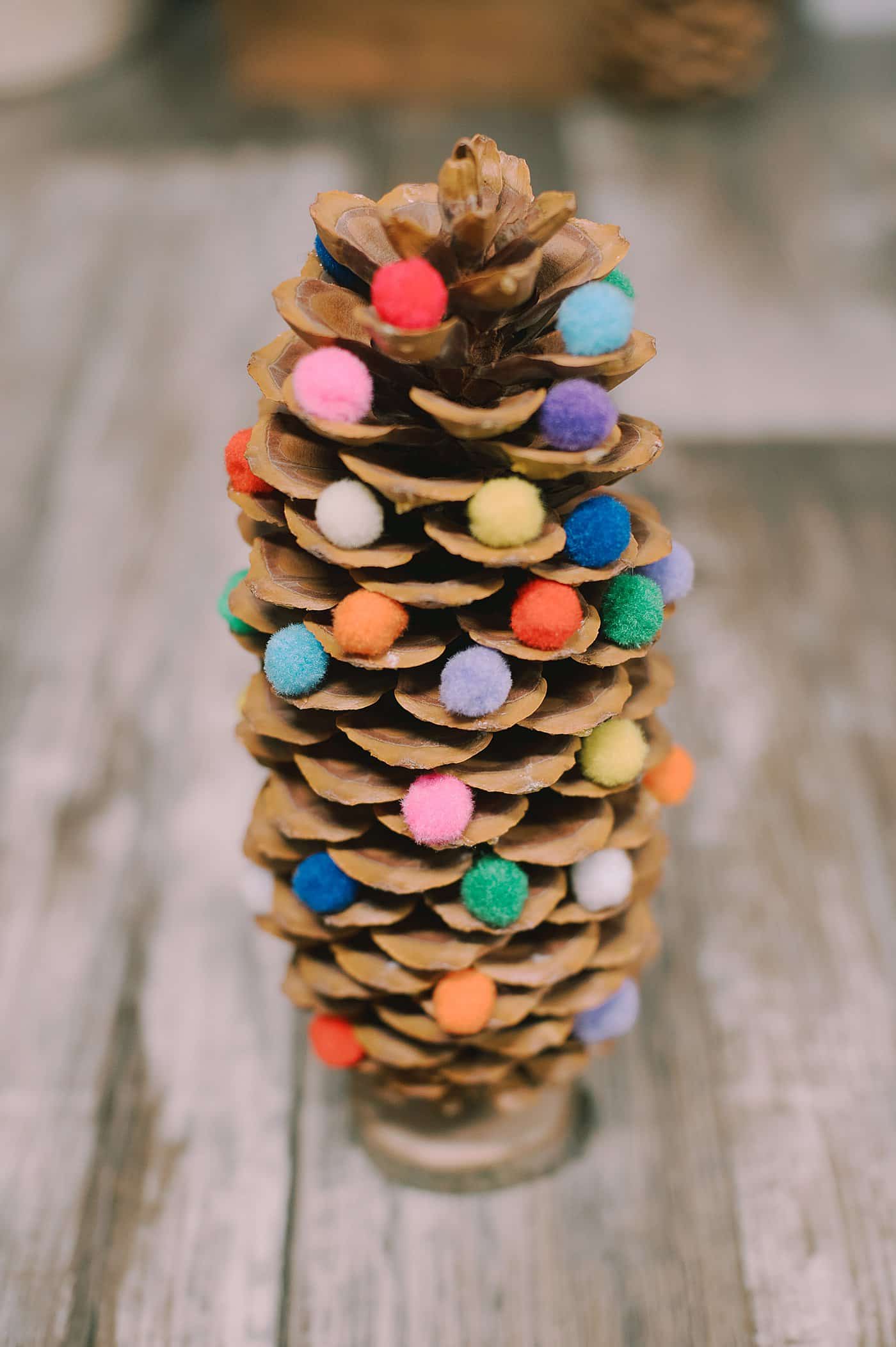 How to make a DIY giant pine cone christmas tree using pom poms.