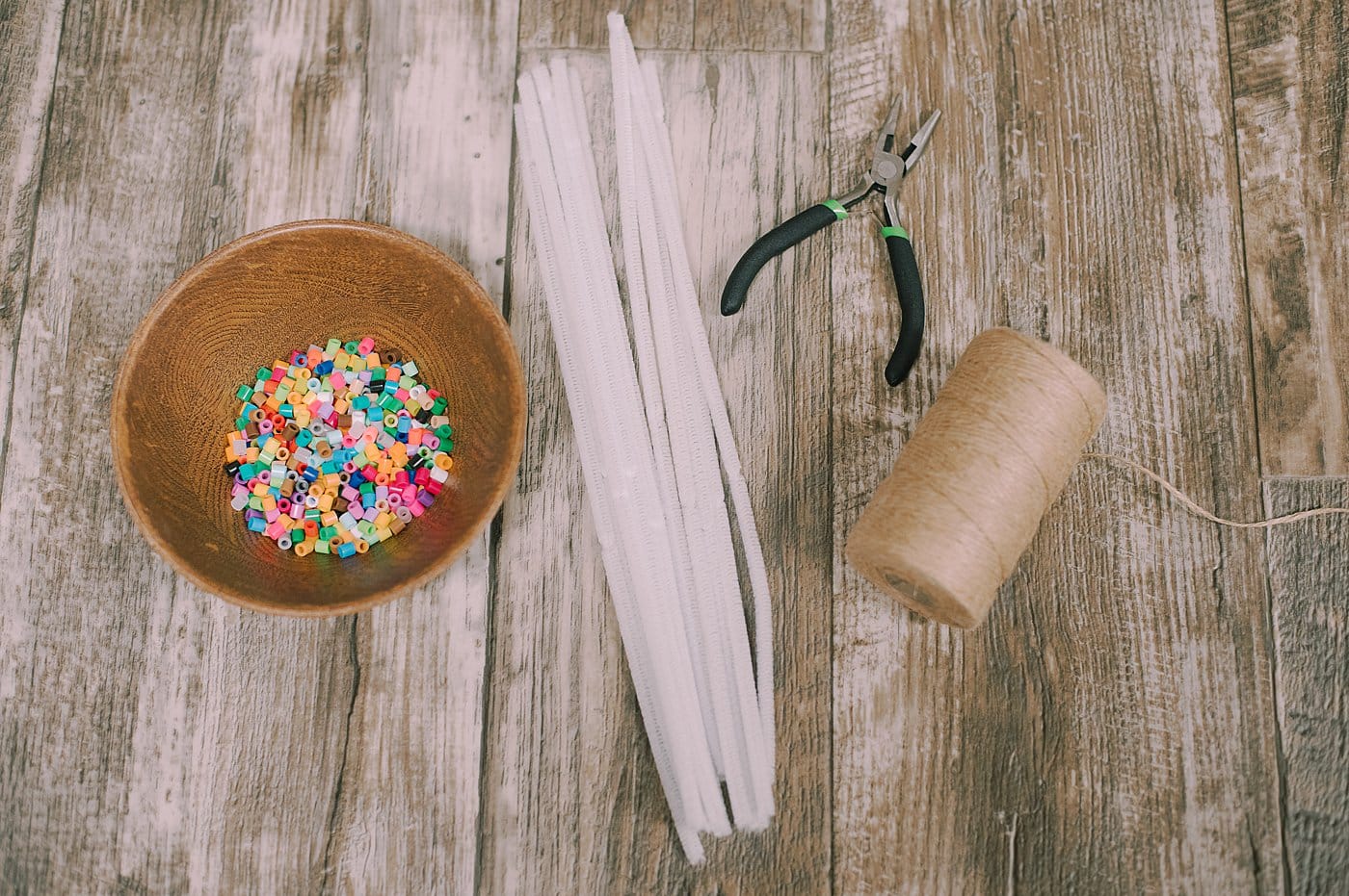 Supplies needed to make Perler Beaded Pipe Cleaner Snowflake Ornaments.