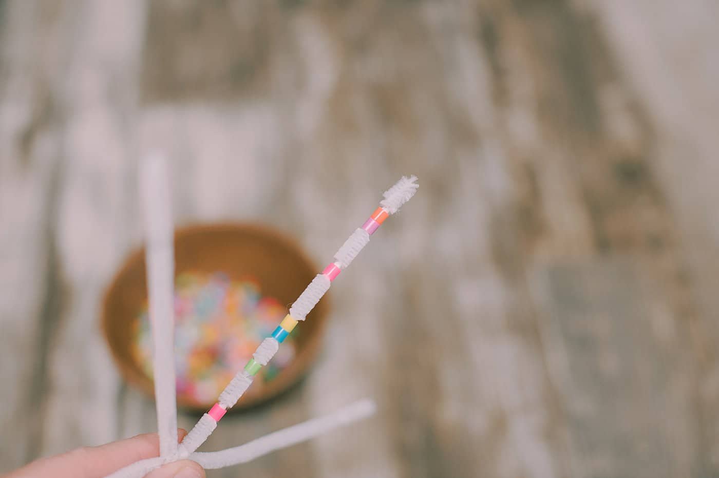 Bend the ends of the pipe cleaner to keep the beads from sliding off.