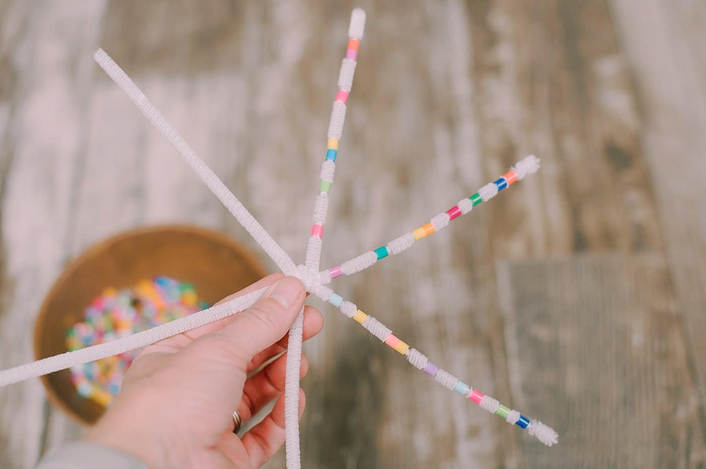 Bend the ends of the pipe cleaner to keep the beads from sliding off.