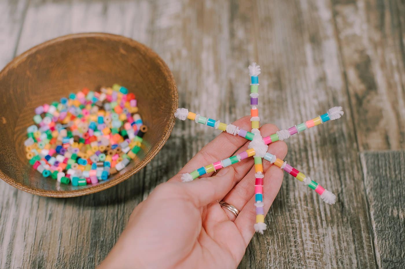 Add perler beads and fold the ends over to secure them on the pipe cleaners.