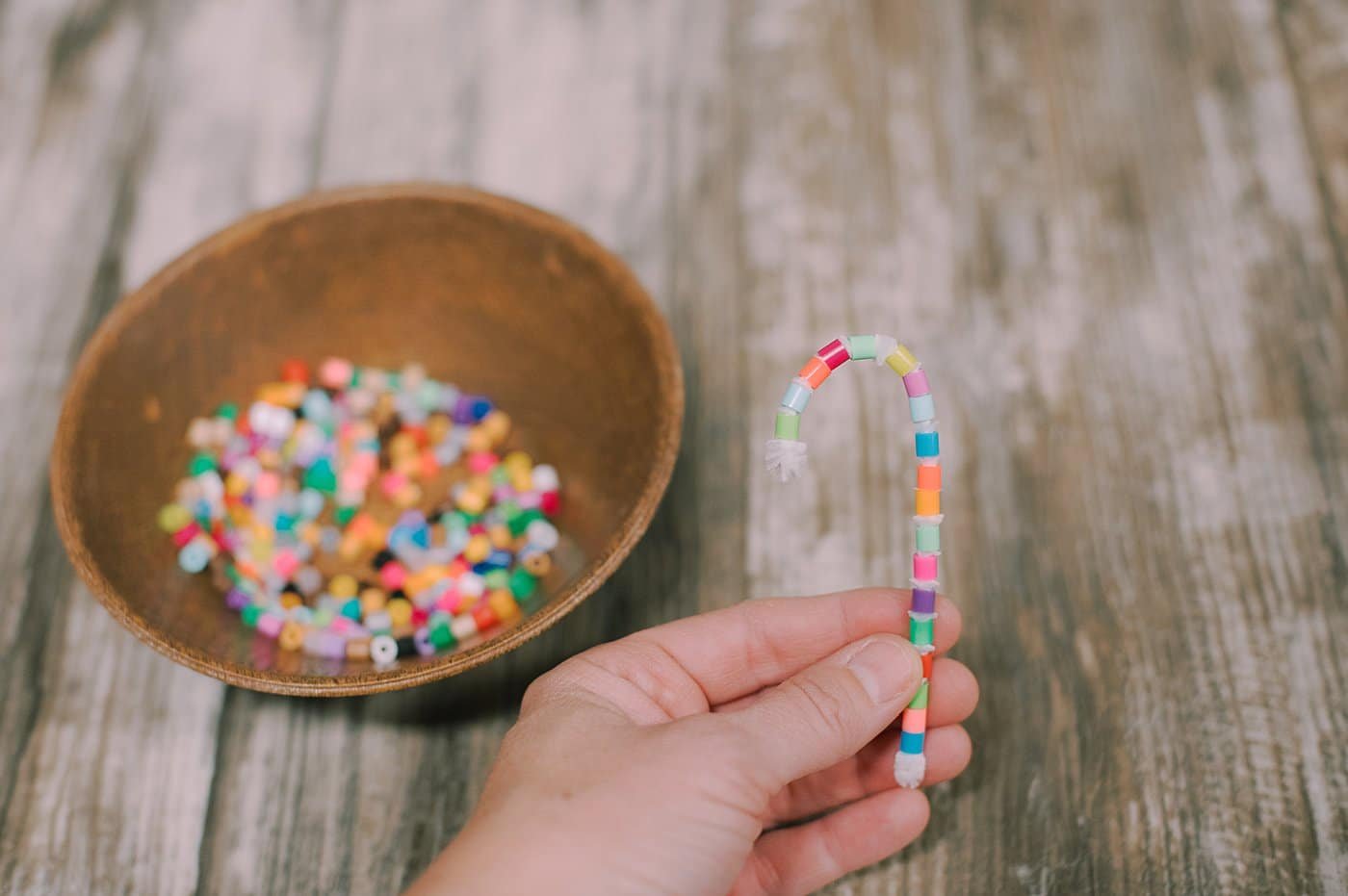 You can add them to a pipe cleaner and bend it into a candy cane shape.