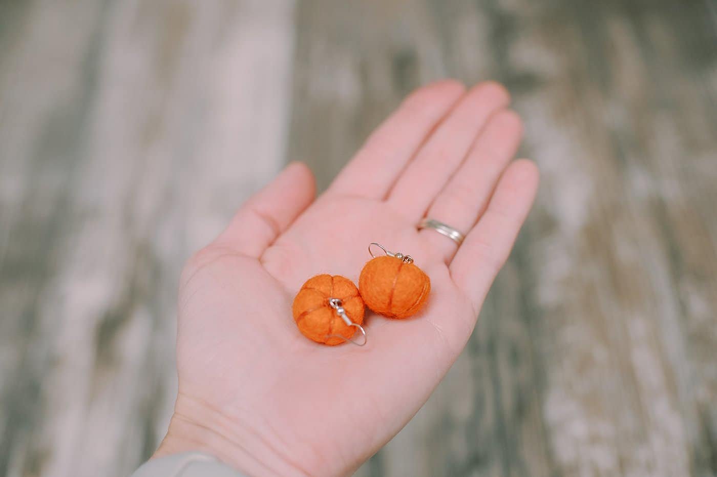 Felt ball pumpkin dangly earrings.