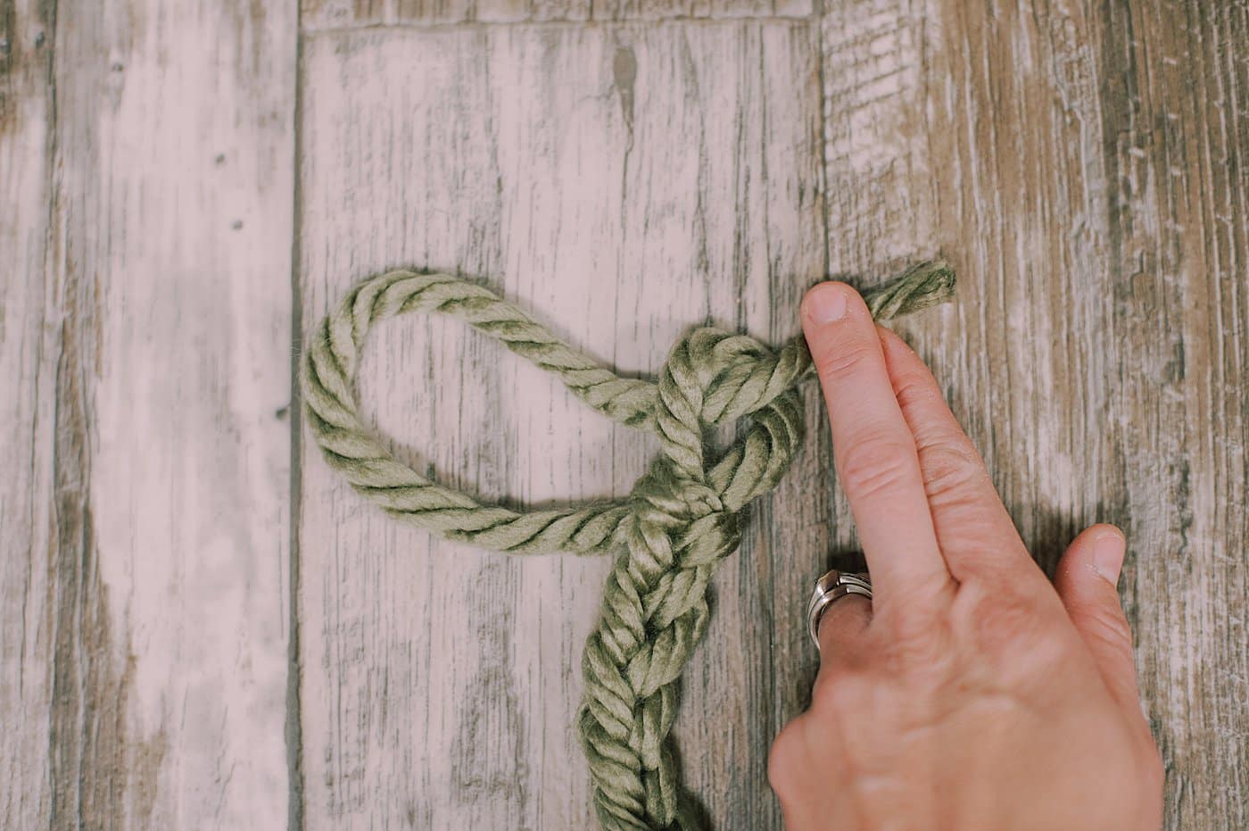 Feed the end of the yarn through the loop. Pull tight.