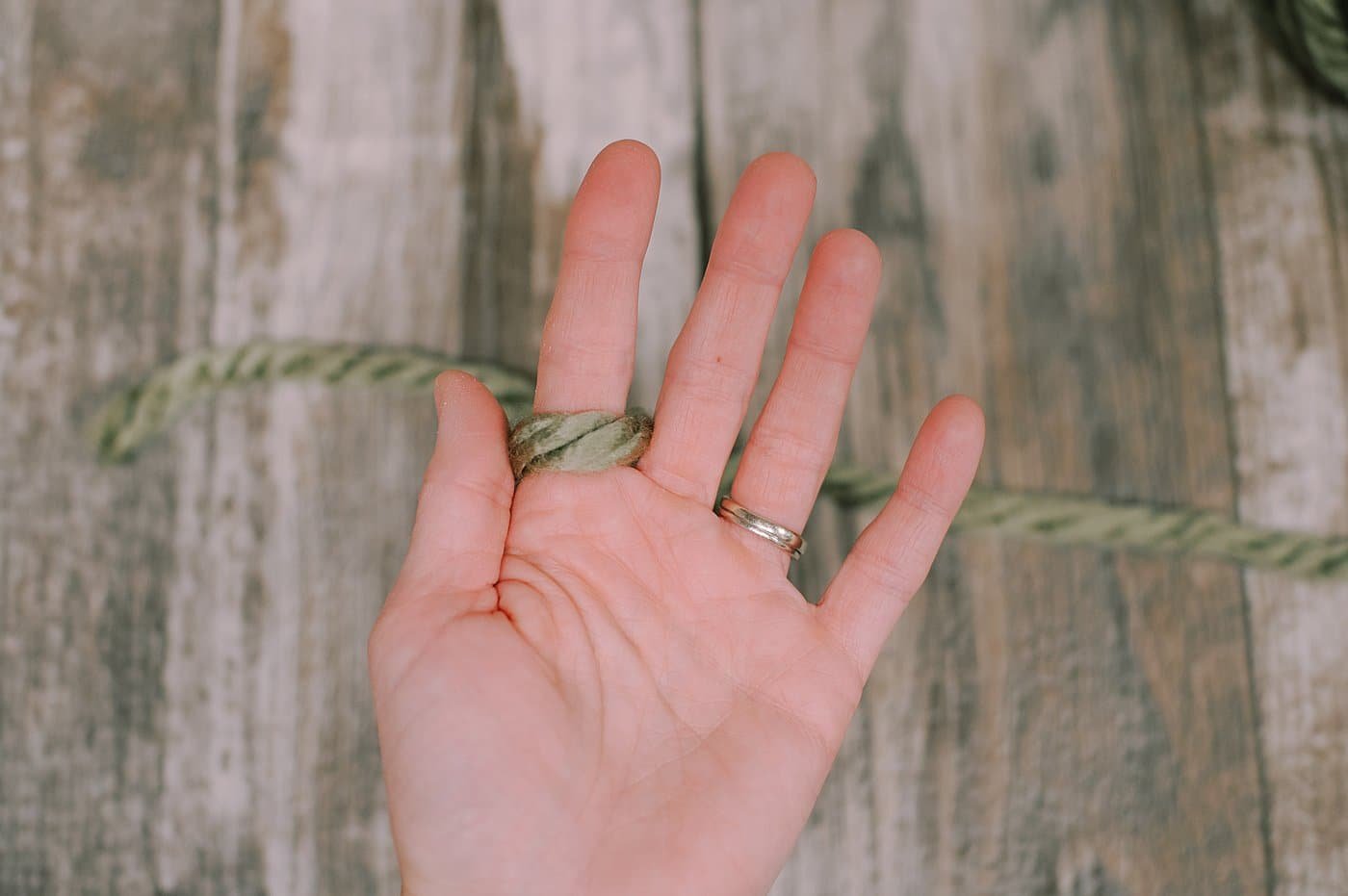 A hand with Chunky Yarn.