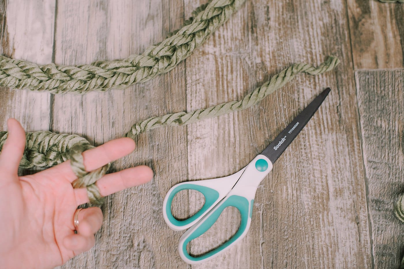 Finishing off a chunky yarn finger-knit garland.