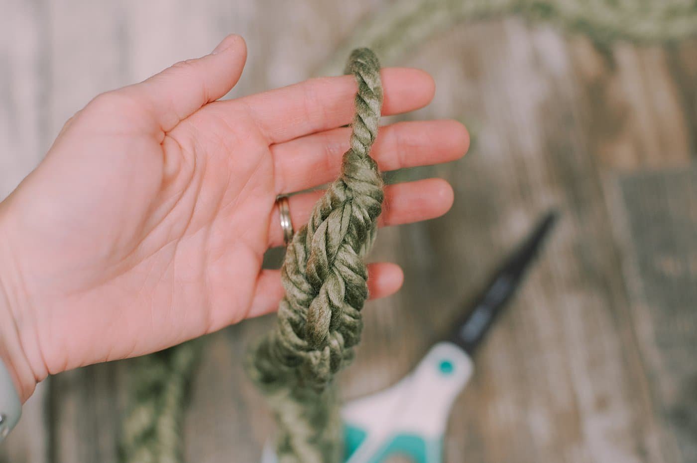 Finishing off a chunky yarn finger-knit garland.