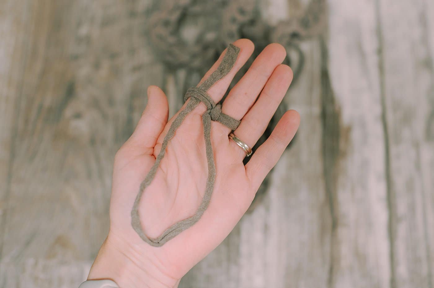 Showing how to cast off finger knitting a garland.