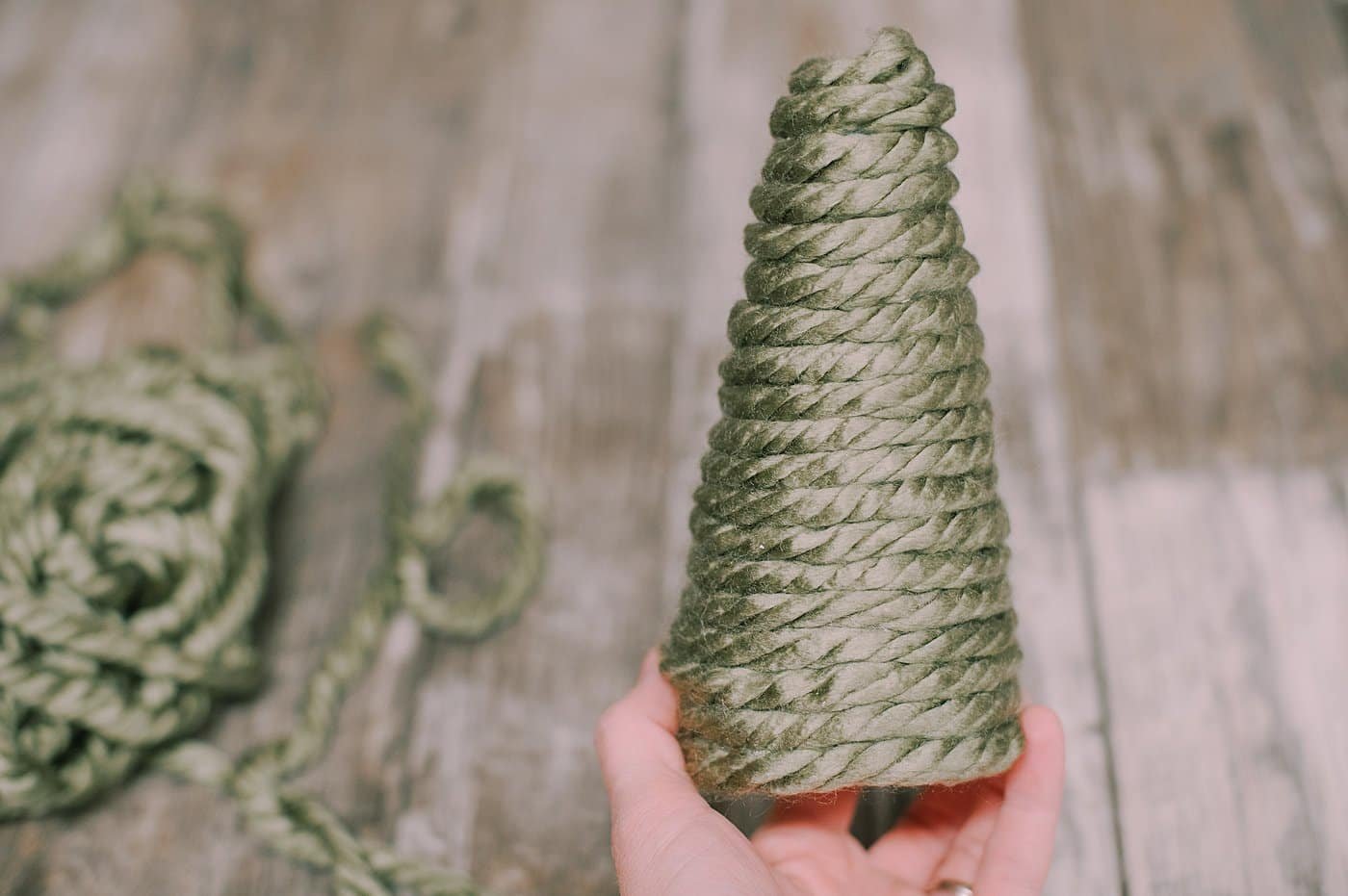 DIY chunky yarn-wrapped styrofoam Christmas tree.