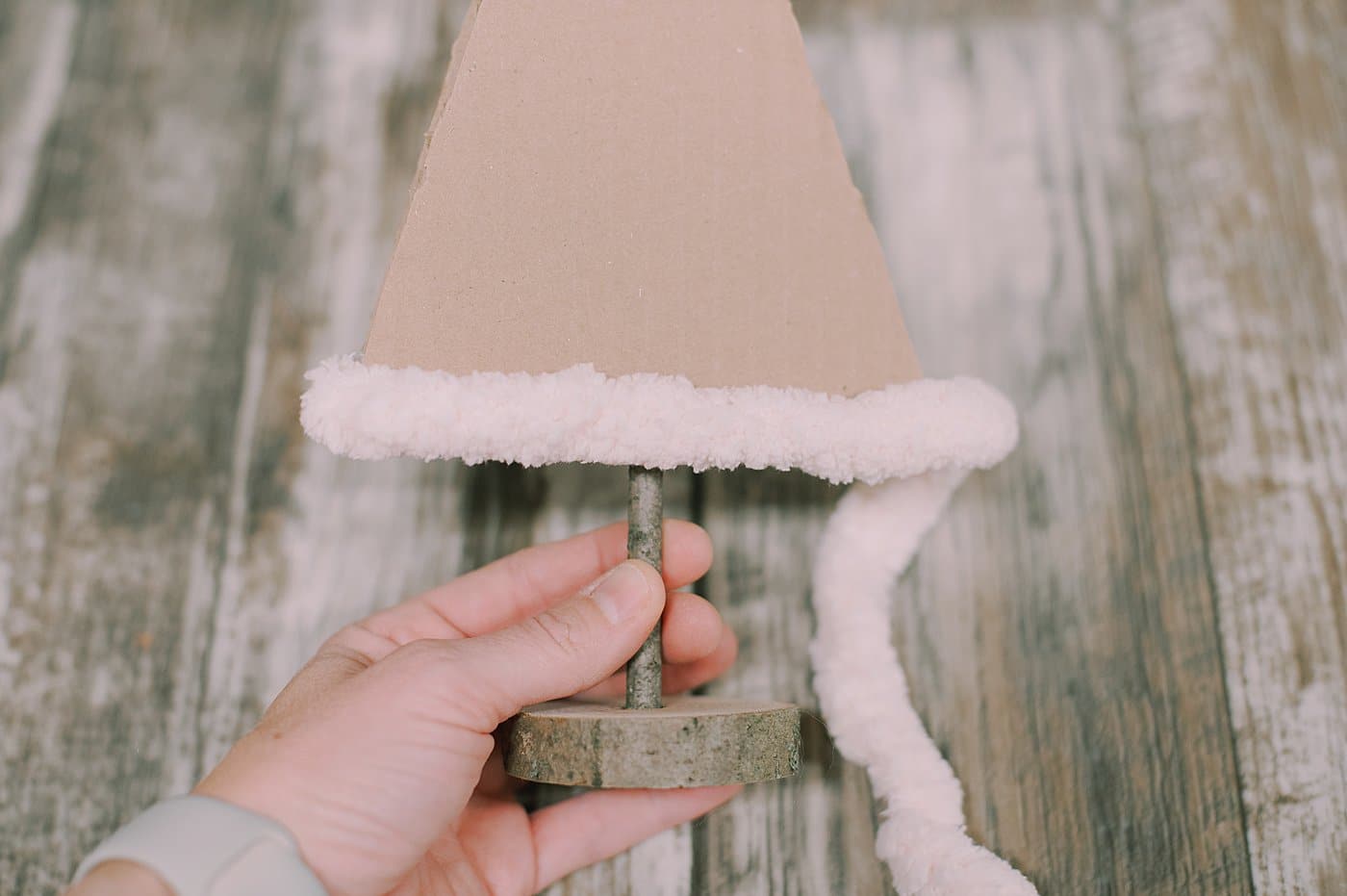 hot glue yarn around the cardboard tree shape