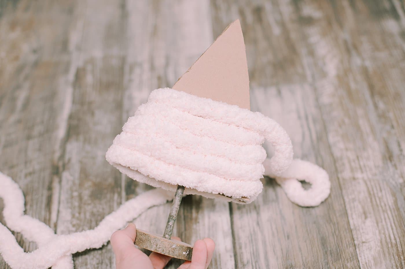 keep wrapping and gluing yarn around the triangle tree shape