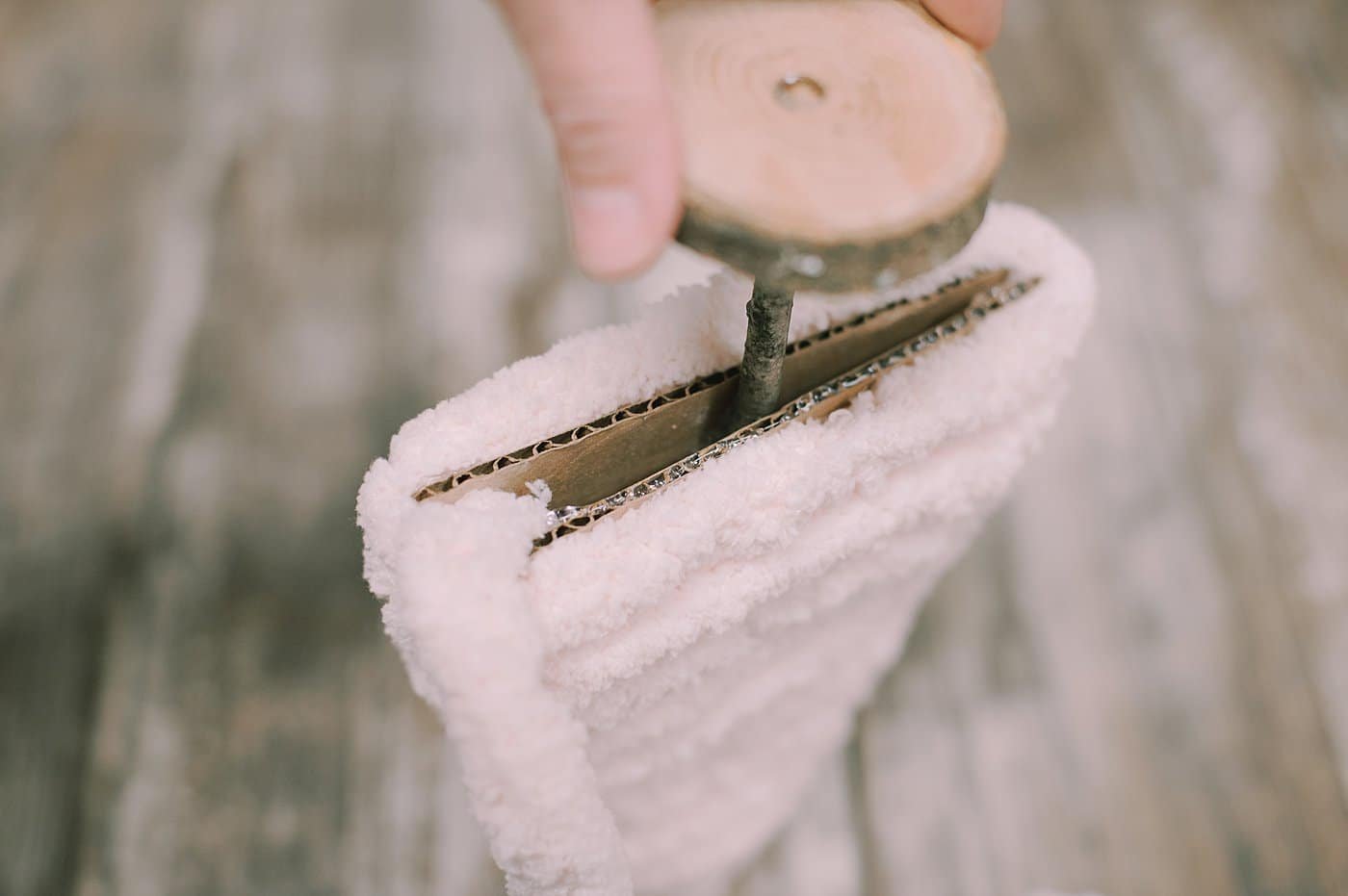 hot glue yarn along the bottom of the cardboard tree to hide the bottom