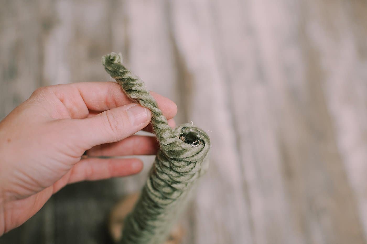 hot glue yarn to the bottom of the cardboard pieces to make a yarn wrapped cardboard tree