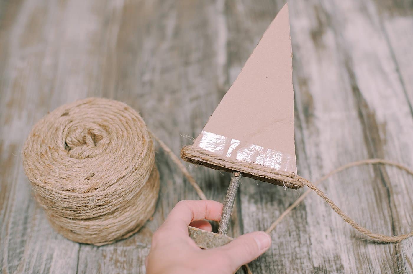 hot glue yarn to the bottom of the cardboard pieces to make a yarn wrapped cardboard tree