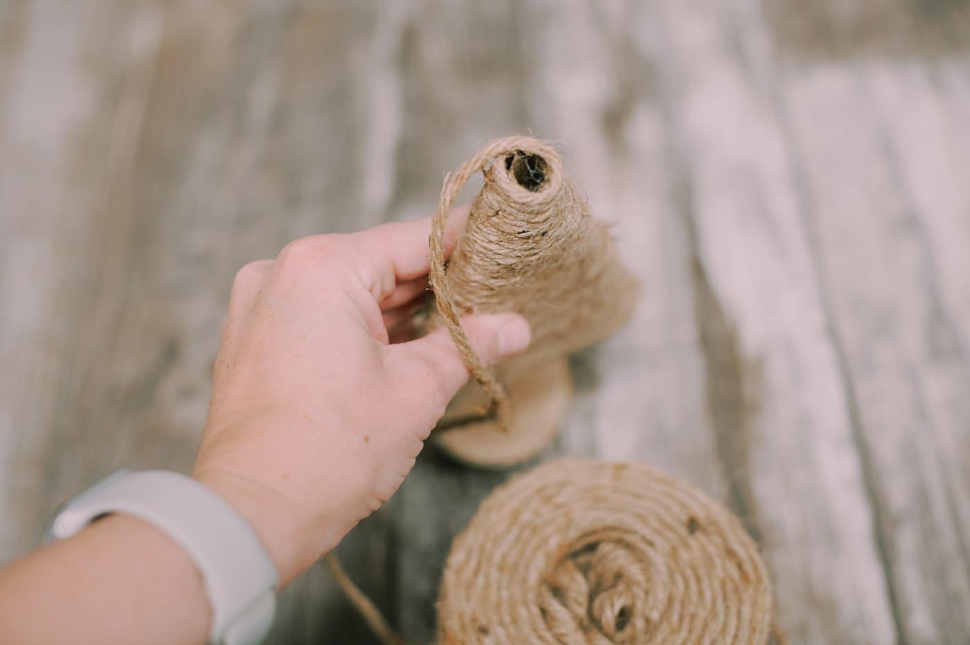 hot glue yarn to the bottom of the cardboard pieces to make a yarn wrapped cardboard tree