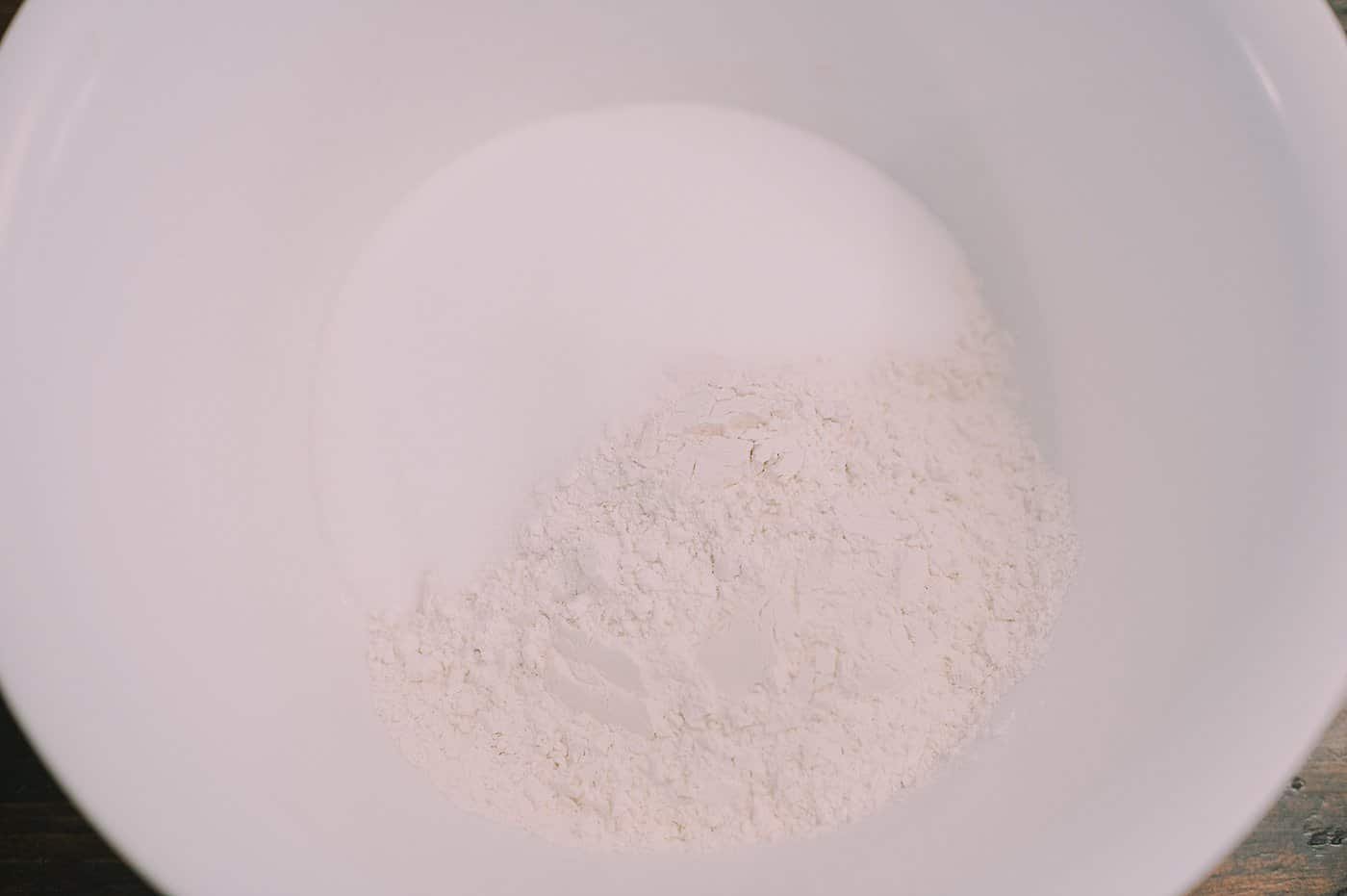 A bowl with flour and salt in it.