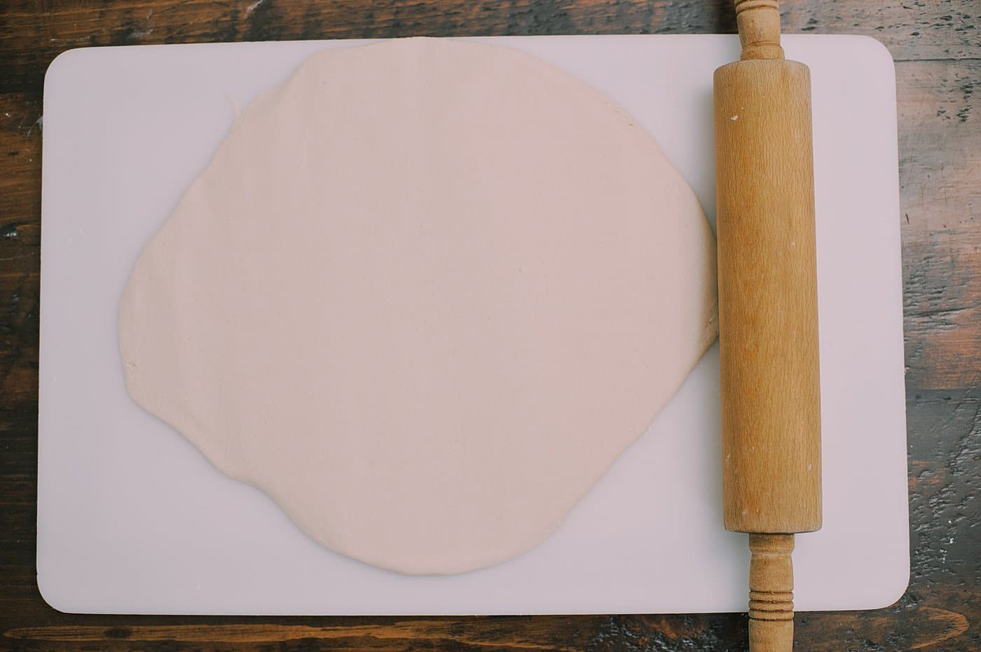 Roll out salt dough into a thin layer before cutting into shapes.