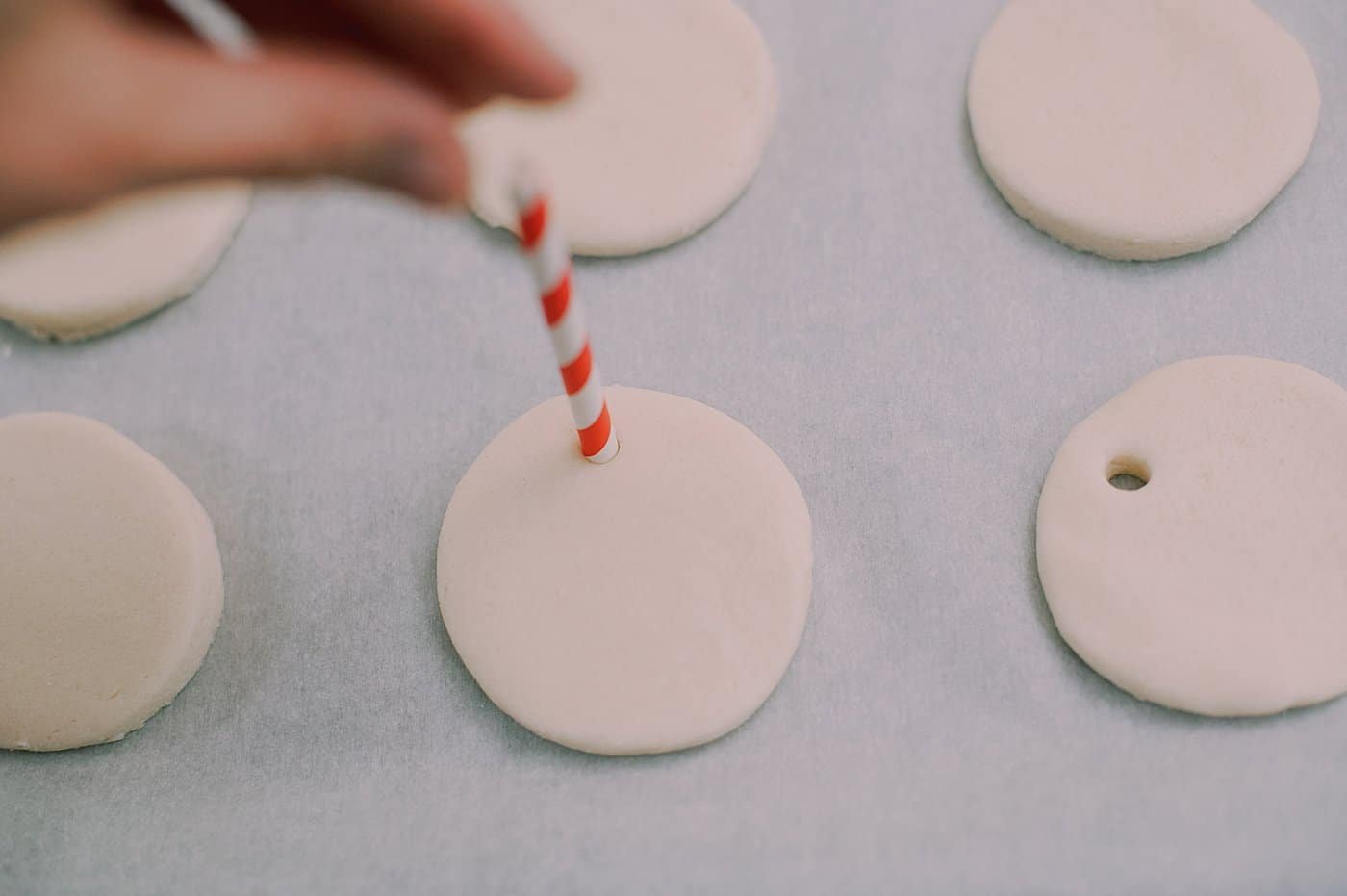 Use a straw to add holes to the top of the salt dough ornaments so you can add a hanging string.