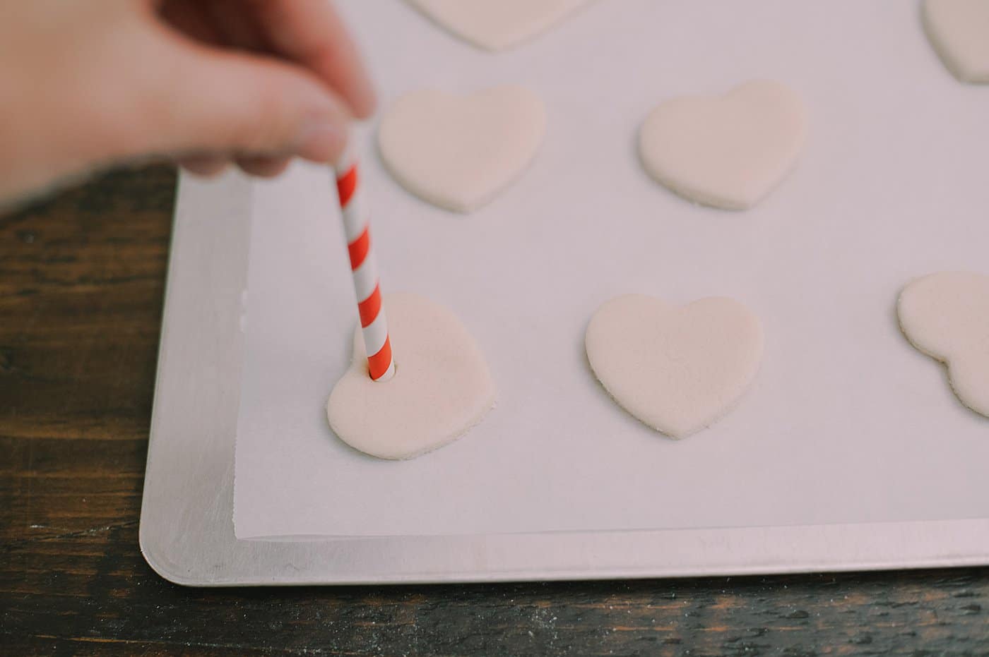 Use a straw to add holes to the top of salt dough ornaments.