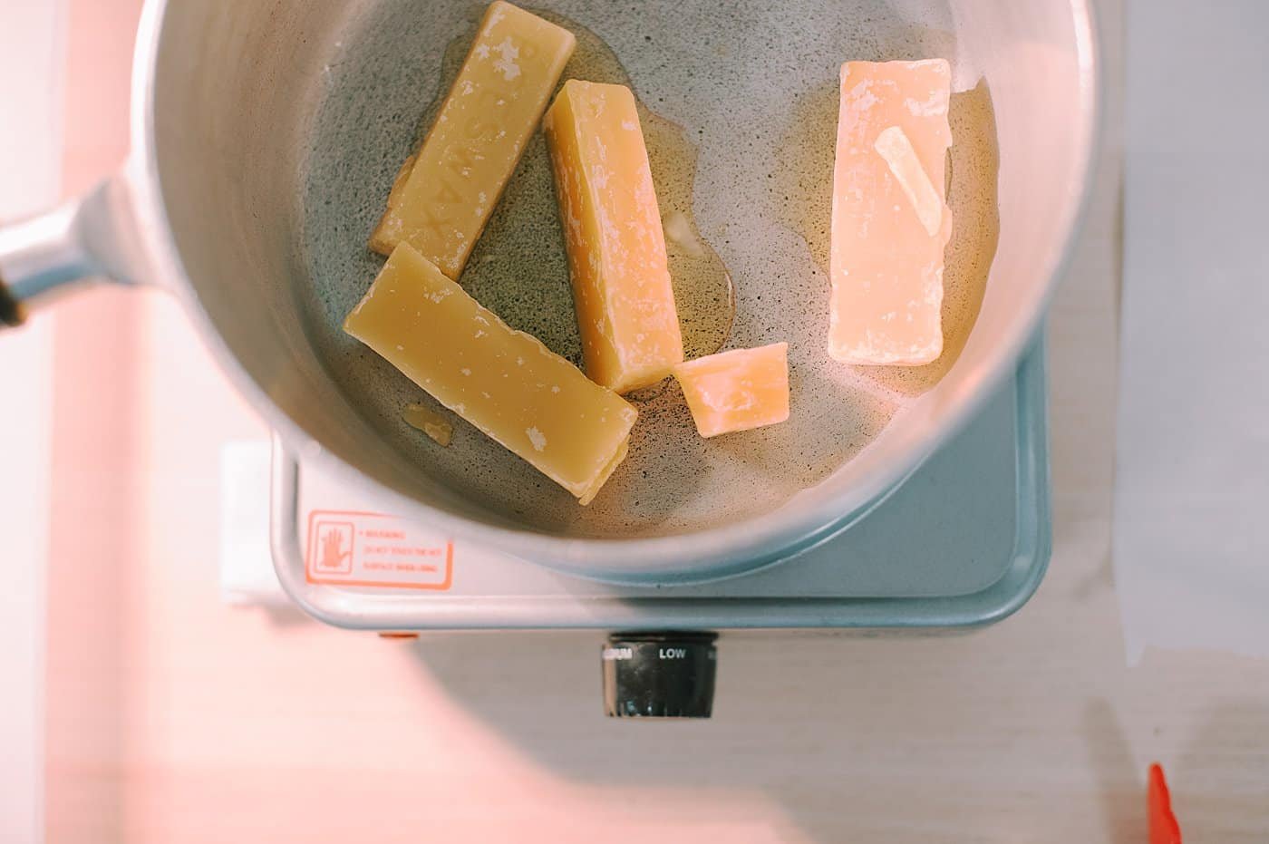 Melt beeswax slowly over low heat.