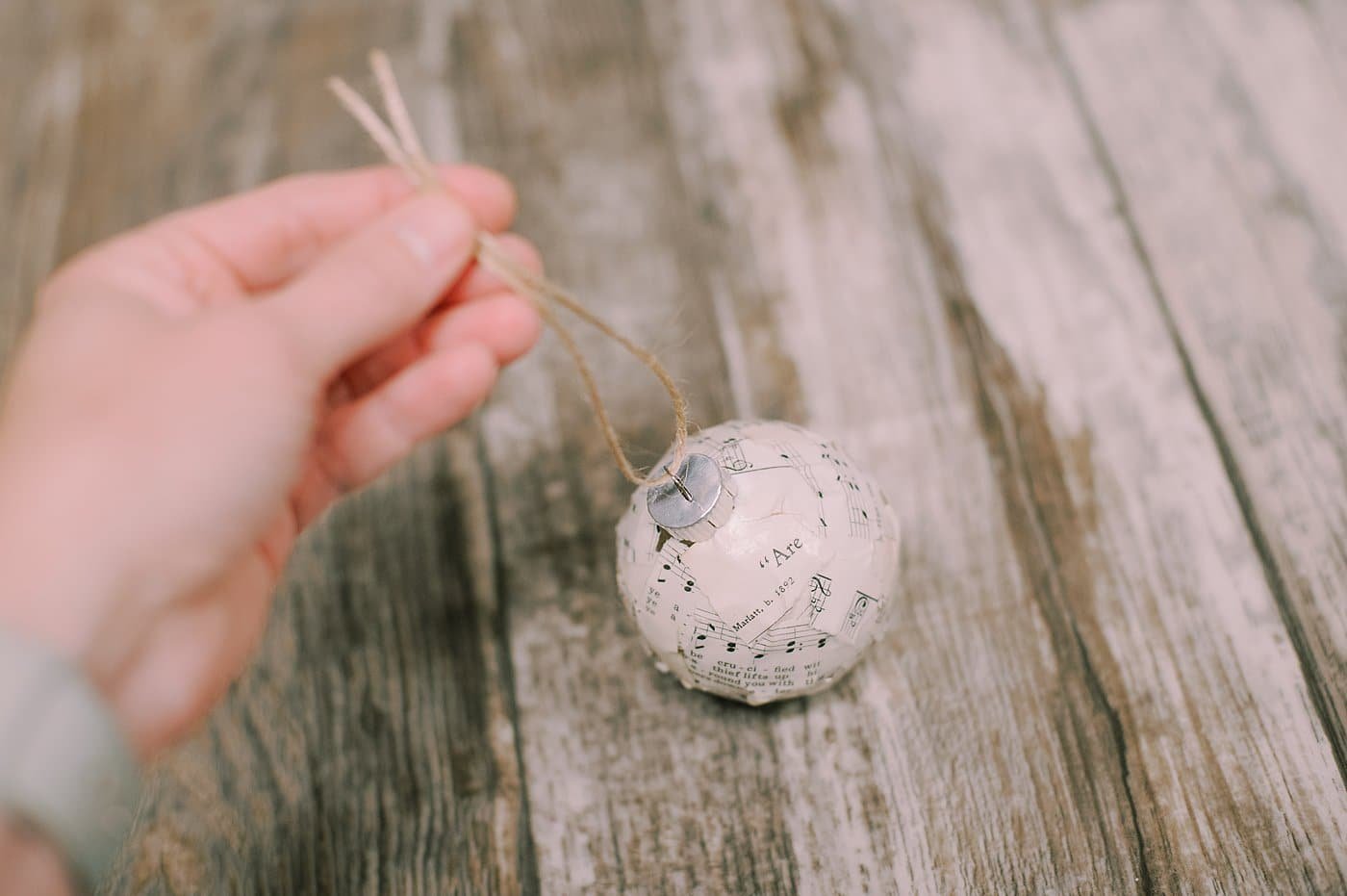 tie twine through the ornament top to hang it