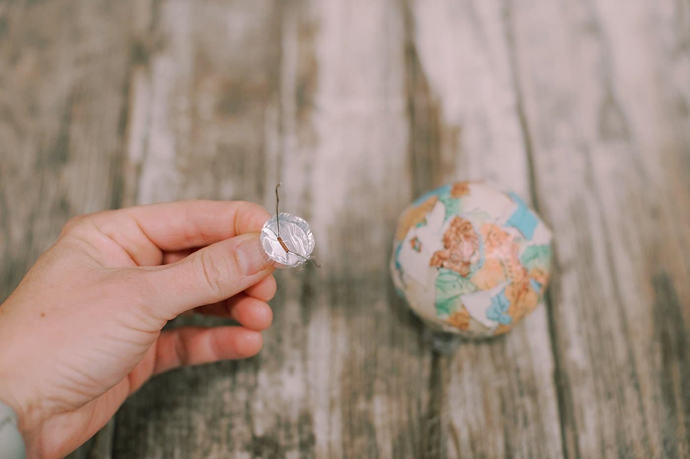 hot glue the top of the ornament to the ball