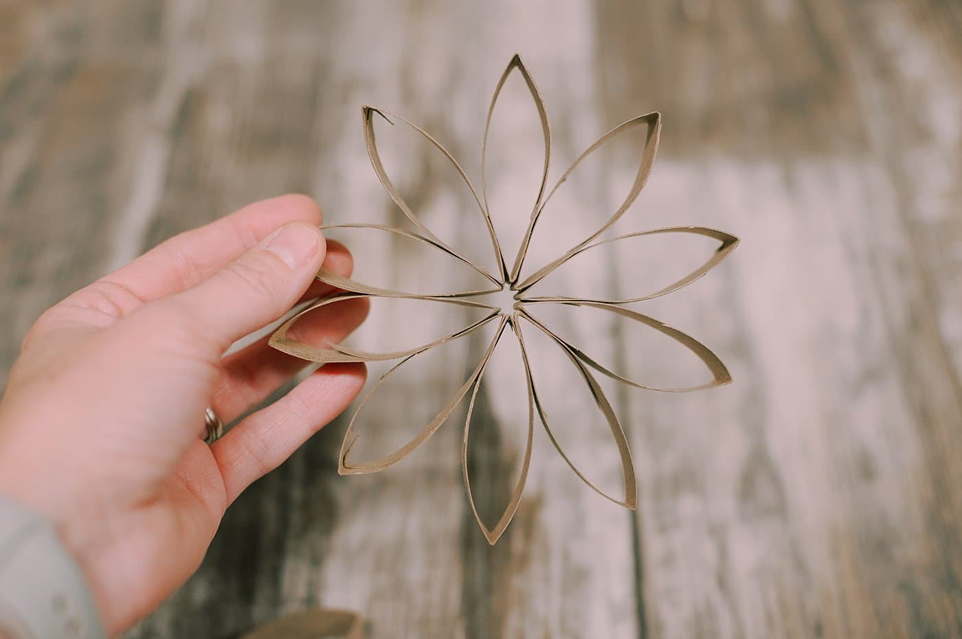 Do the same thing with sections that haven't been folded, and the more you add, the more intricate the toilet paper flower will be.