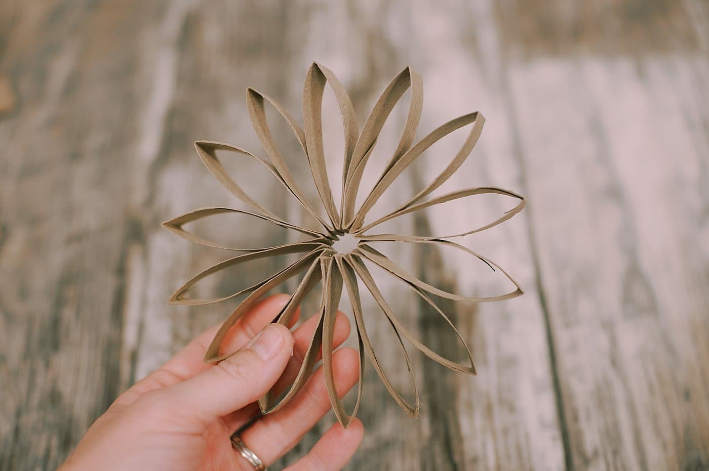 Do the same thing with sections that haven't been folded, and the more you add, the more intricate the toilet paper flower will be.