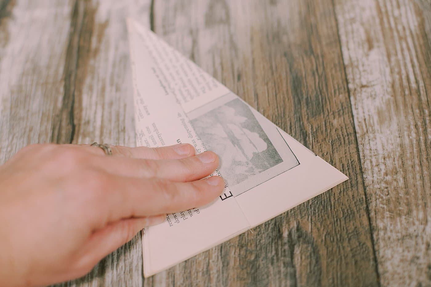 Fold paper back on triangle book pages.