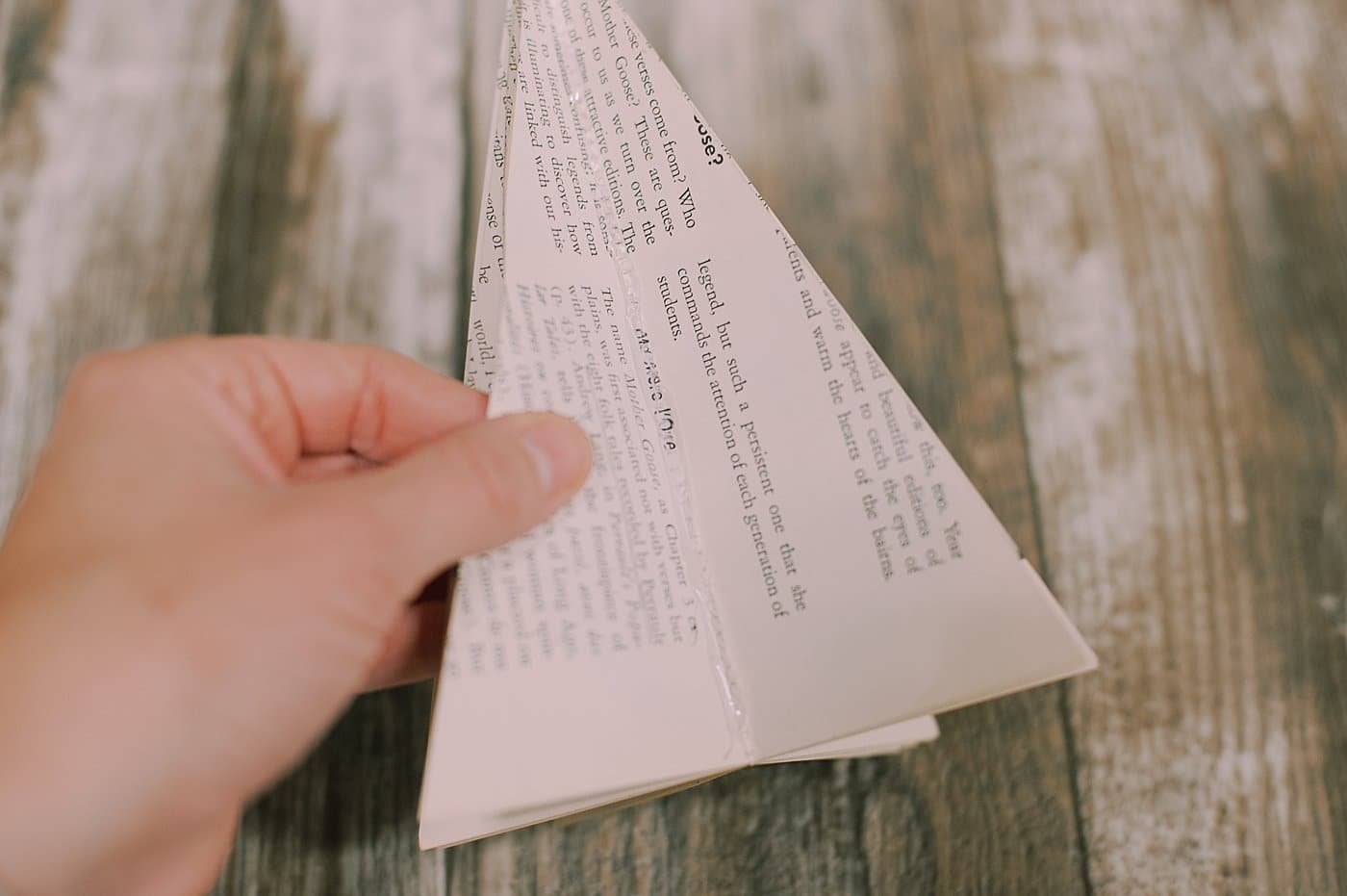 Fold paper back on triangle book pages.