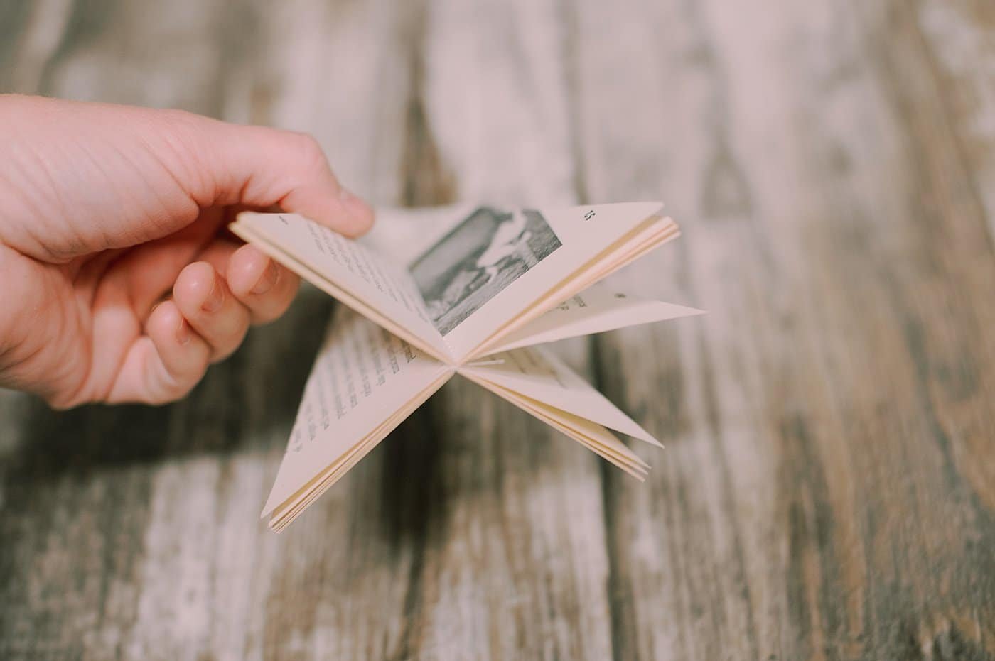 Fold paper back on triangle book pages.