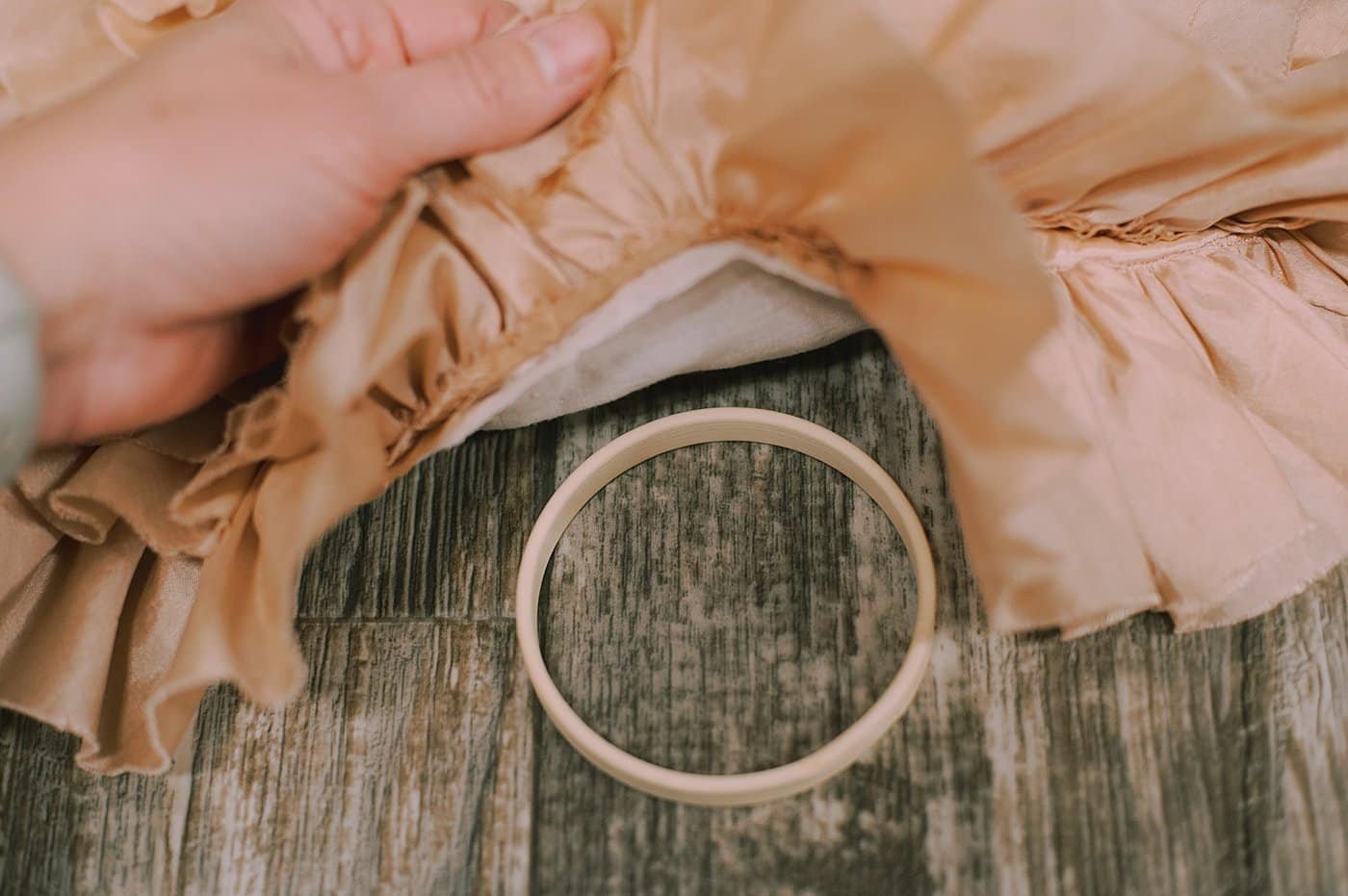 Place the inner embroidery hoop under the fabric.