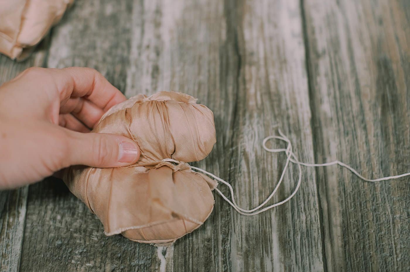 Thread a hanging string through the top of the memory ornament.