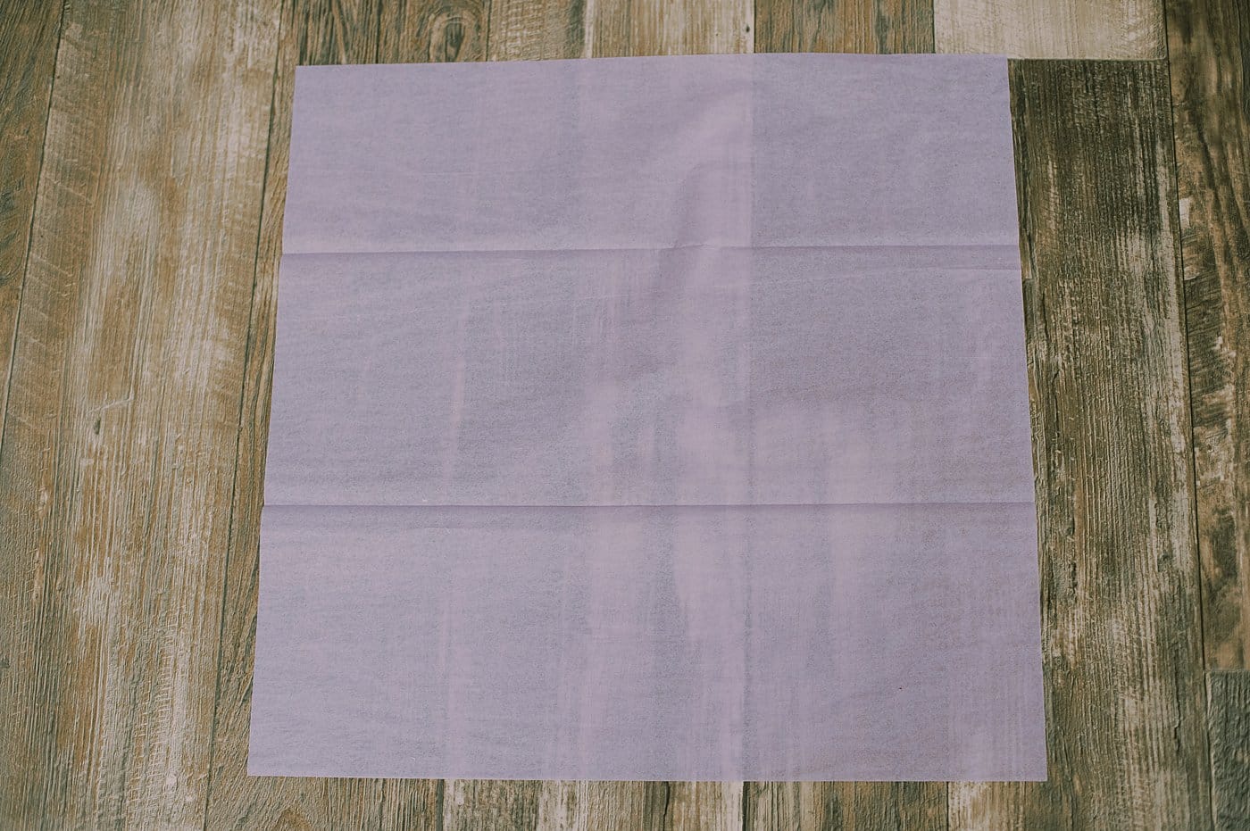 Fold a piece of tissue paper in half.