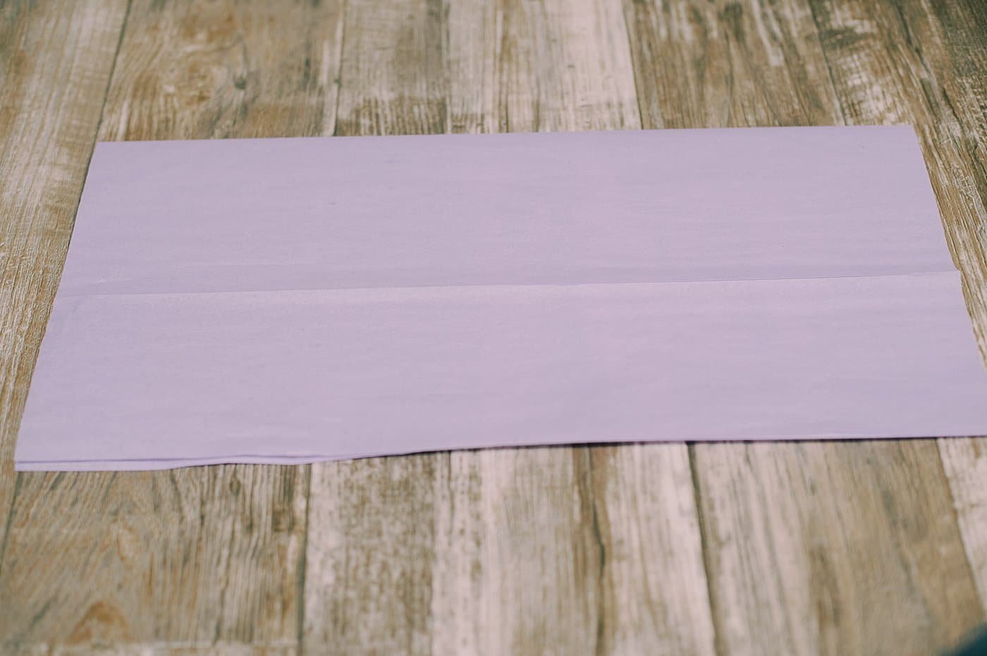 Fold a piece of tissue paper in half.