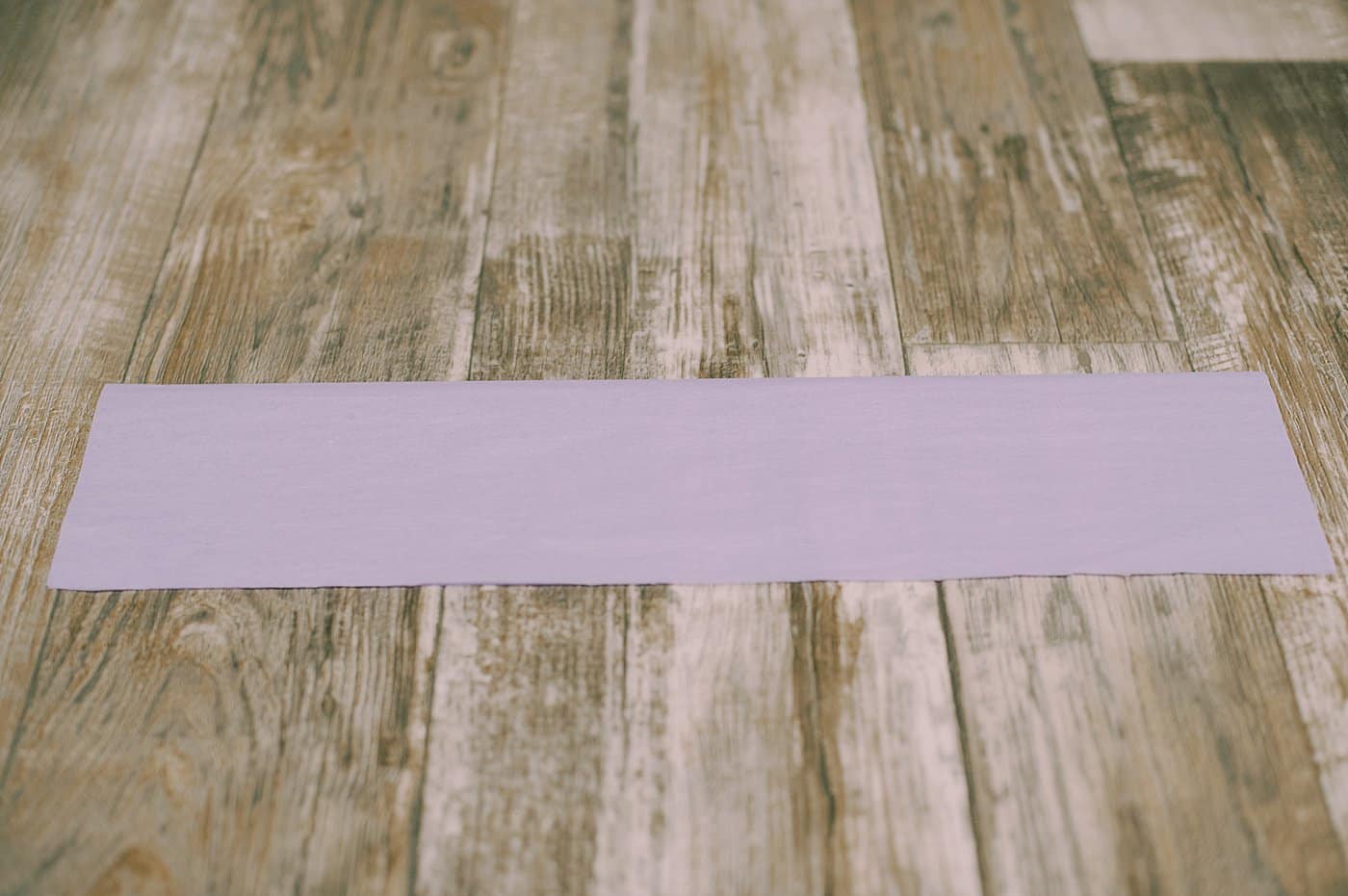 Cut along the bottom edge of the tissue paper, about ½" to ¾" thick strips.
