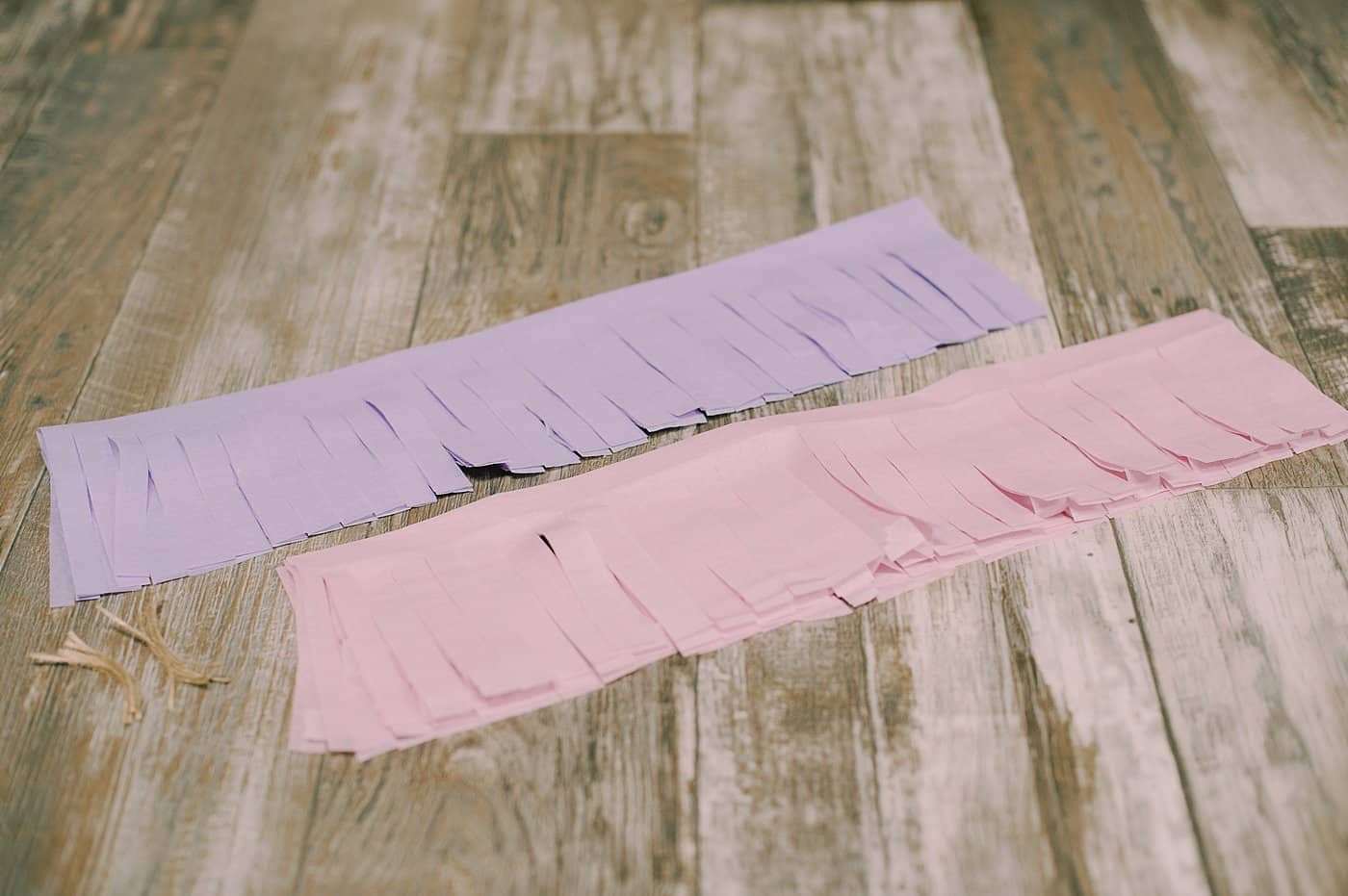 Two sections of tissue paper with fringe cut in the bottom.