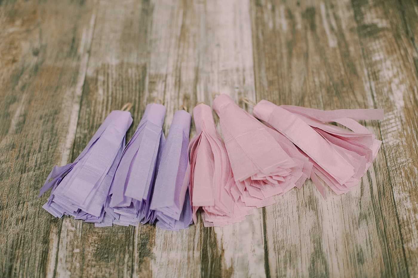 Tissue paper tassels laying next to each other.
